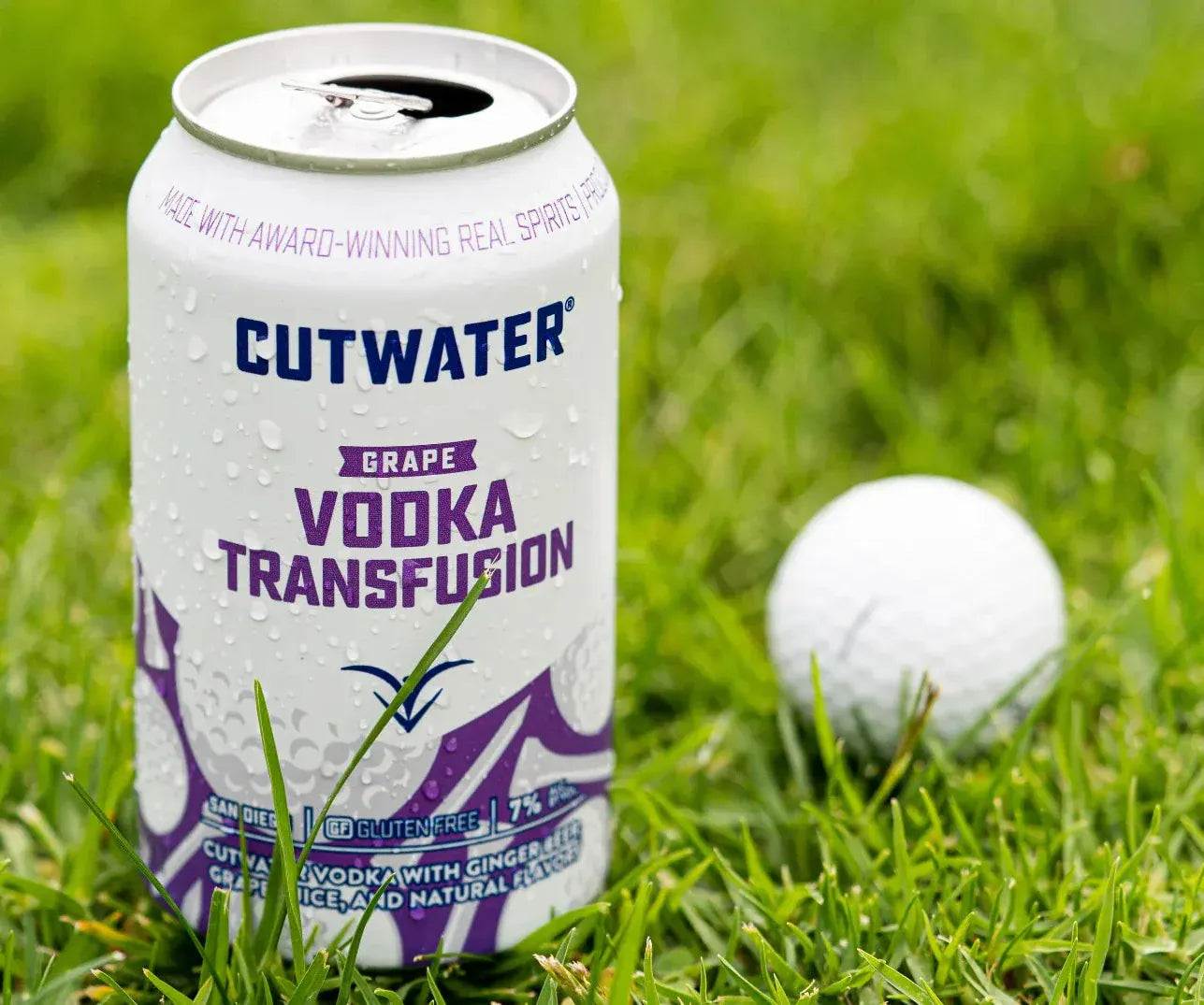 Cutwater Vodka Transfusion can on grass next to a golf ball