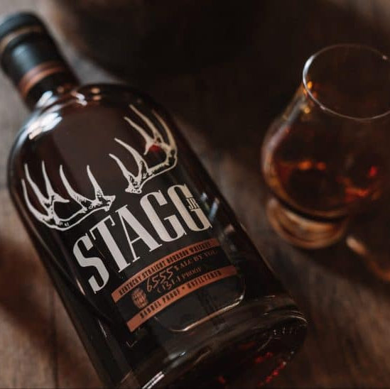 Stag's Leap whiskey bottle with a glass on a wooden surface