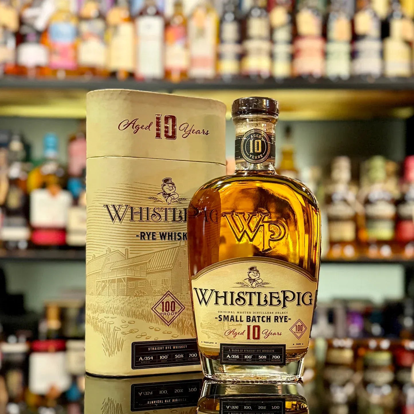 WhistlePig Rye Whiskey bottle and packaging on a bar shelf background