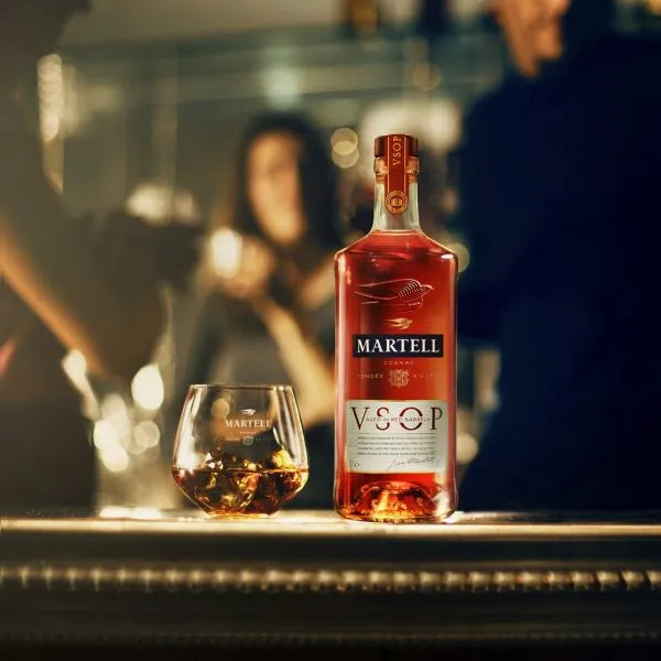 Martell VSOP Red Barrel Cognac bottle with glass of cognac on bar, premium French cognac with smooth vanilla and oak notes