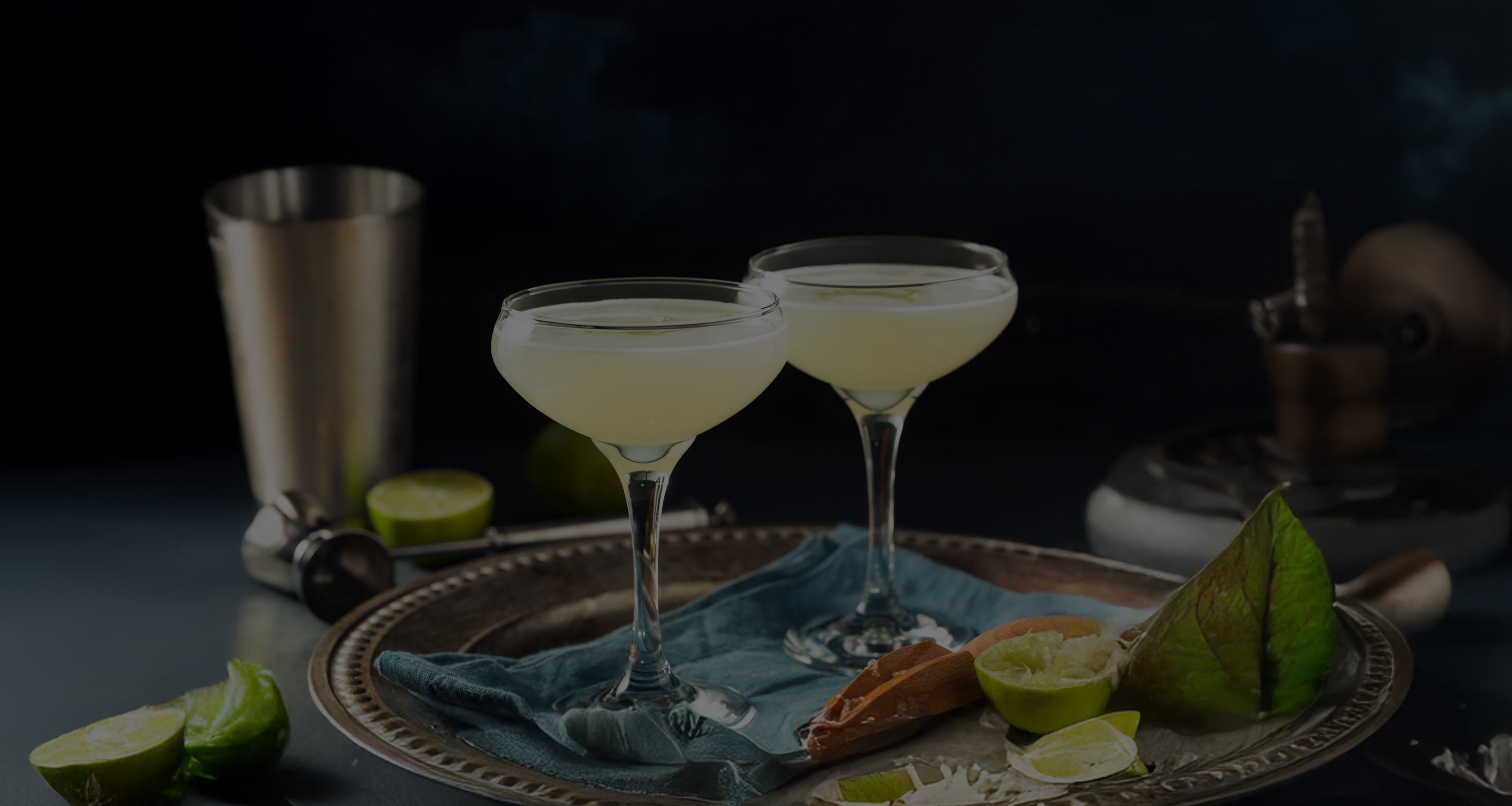 Gin cocktail sitting on a dark desk with a dark background