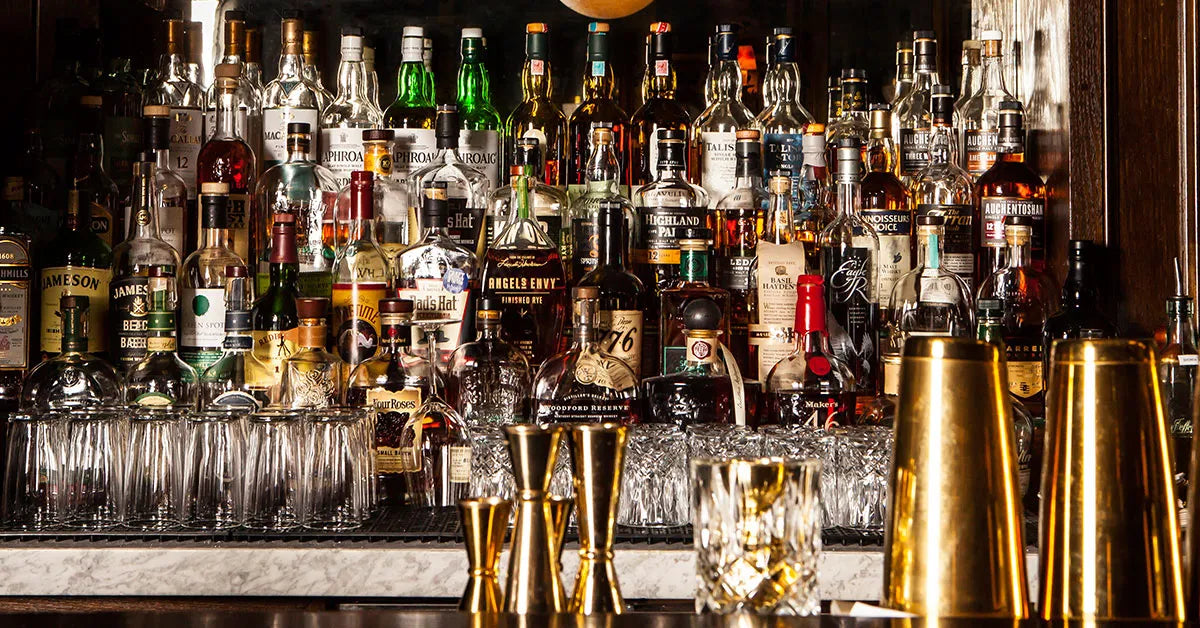 Premium spirits lining the back wall of a premium bar