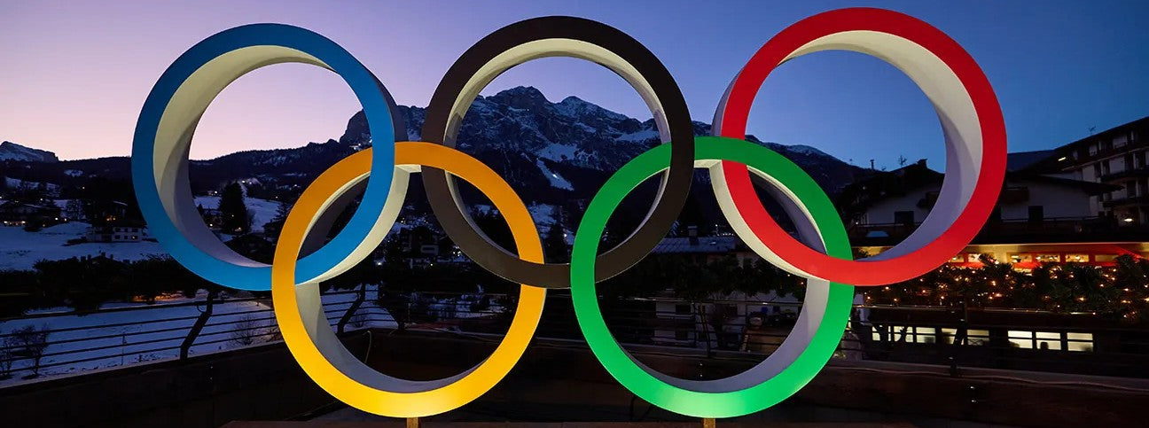 Olympic rings with a mountainous landscape in the background
